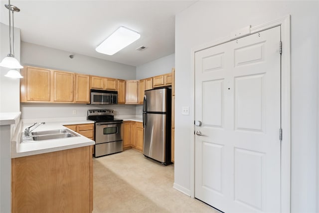 1313 SE University Ave Unit 206, Waukee, IA 50263 - kitchen featuring appliances with stainless steel finishes, light countertops, light floors, and hanging light fixtures