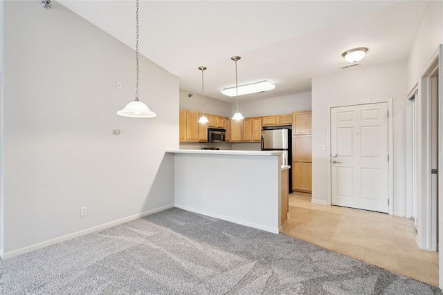 1313 SE University Ave Unit 206, Waukee, IA 50263 - kitchen with appliances with stainless steel finishes, light colored carpet, pendant lighting, and a peninsula