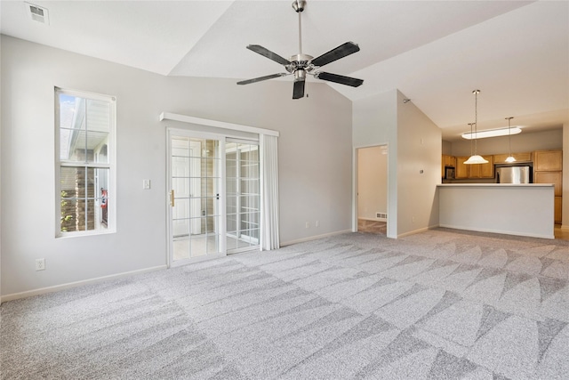 1313 SE University Ave Unit 206, Waukee, IA 50263 - unfurnished living room with lofted ceiling, ceiling fan, and light colored carpet