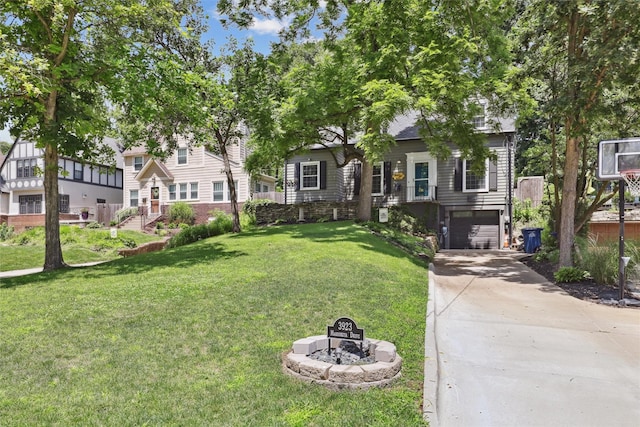 3923 Maquoketa Dr, Des Moines, IA 50311 - view of front facade featuring driveway, an attached garage, a front yard, and a fire pit
