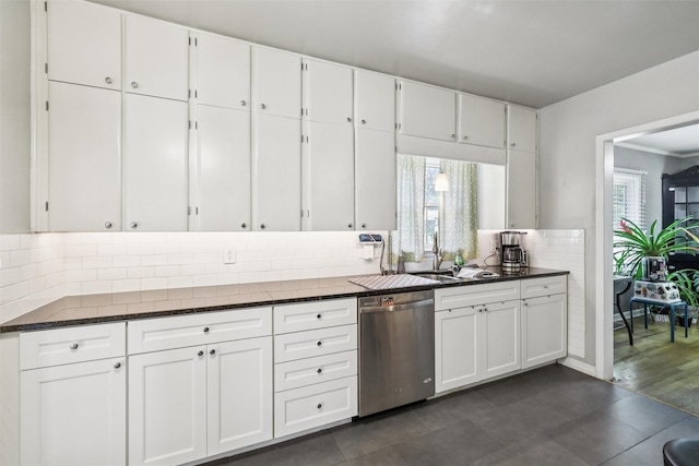 3923 Maquoketa Dr, Des Moines, IA 50311 - kitchen featuring dishwasher, plenty of natural light, backsplash, and white cabinets