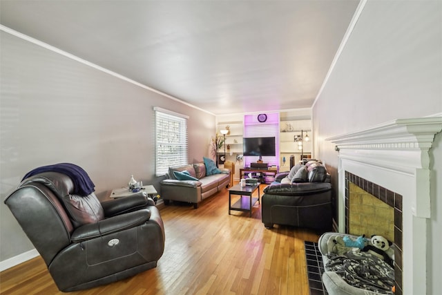 3923 Maquoketa Dr, Des Moines, IA 50311 - living area featuring a fireplace with flush hearth, wood-type flooring, and crown molding