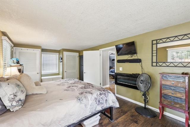 3923 Maquoketa Dr, Des Moines, IA 50311 - bedroom with a textured ceiling, wood finished floors, and multiple closets