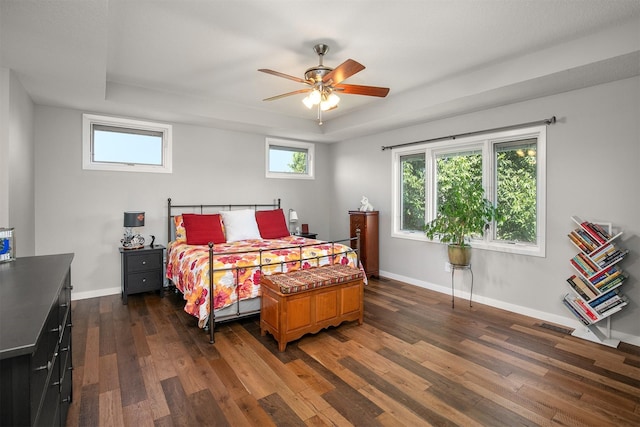 13001 Twana Dr, Urbandale, IA 50323 - bedroom featuring dark wood-type flooring, a raised ceiling, and a ceiling fan