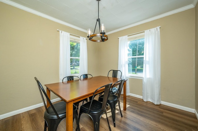 512 11th St, West Des Moines, IA 50265 - dining space featuring a chandelier, dark wood-style floors, and ornamental molding