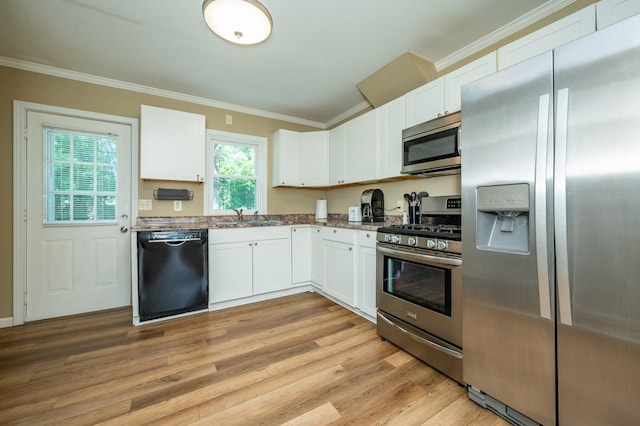 512 11th St, West Des Moines, IA 50265 - kitchen with stainless steel appliances, white cabinets, ornamental molding, light wood finished floors, and dark stone countertops