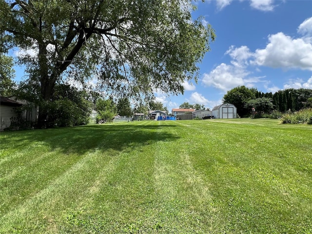 314 E 14th St N, Newton, IA 50208 - view of green lawn featuring a storage unit