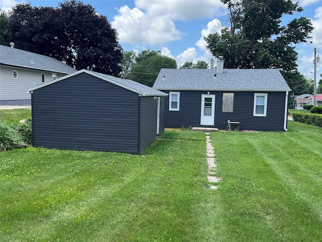 314 E 14th St N, Newton, IA 50208 - rear view of house with a lawn, a chimney, and a shingled roof