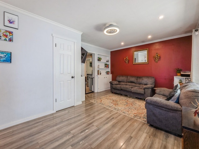 2300 Locust St, West Des Moines, IA 50265 - living area featuring wood finished floors, crown molding, recessed lighting, and built in shelves