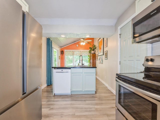2300 Locust St, West Des Moines, IA 50265 - kitchen with appliances with stainless steel finishes, lofted ceiling, light wood finished floors, dark countertops, and a ceiling fan