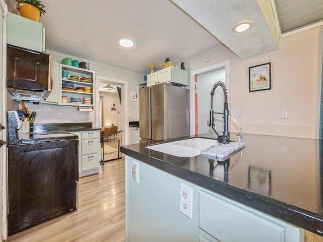 2300 Locust St, West Des Moines, IA 50265 - kitchen with freestanding refrigerator, stove, dark countertops, light wood-style flooring, and open shelves