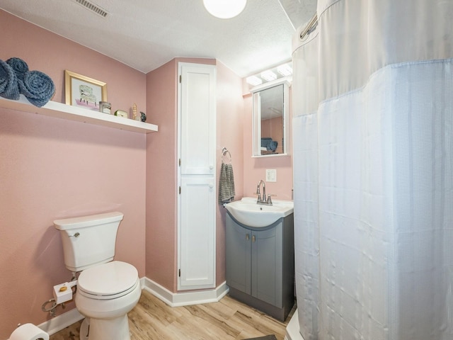 2300 Locust St, West Des Moines, IA 50265 - bathroom with wood finished floors, vanity, and a shower with curtain