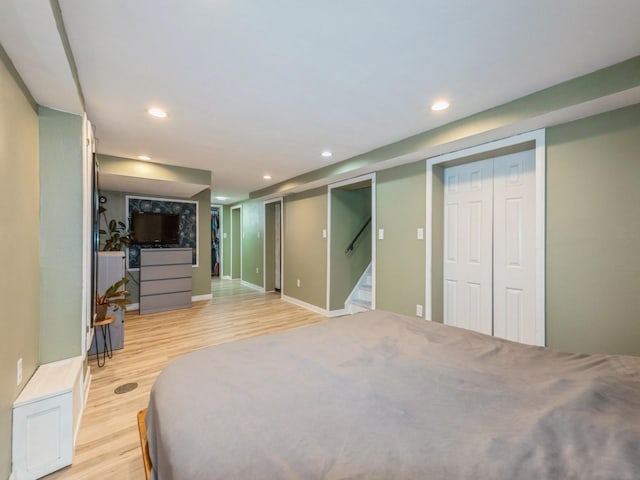 2300 Locust St, West Des Moines, IA 50265 - bedroom with light wood-style floors, recessed lighting, and multiple closets