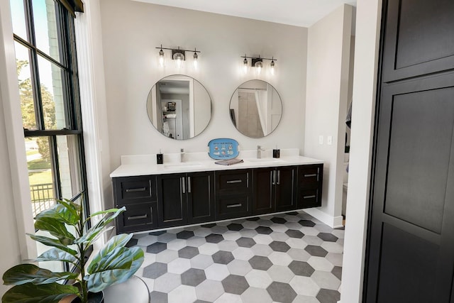 710 Peace St Unit 3D, Pella, IA 50219 - bathroom featuring healthy amount of natural light, double vanity, and tile patterned floors