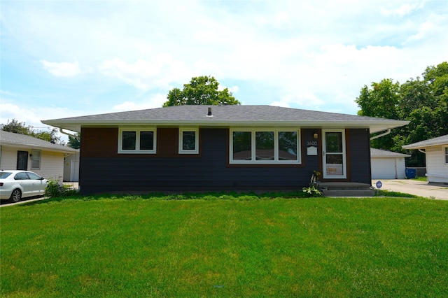3600 Brinkwood Rd, Des Moines, IA 50310 - view of front facade with a front lawn, a garage, and an outbuilding
