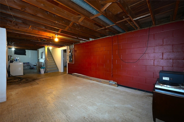 3600 Brinkwood Rd, Des Moines, IA 50310 - unfinished basement featuring stairway, washer / clothes dryer, electric panel, and concrete block wall