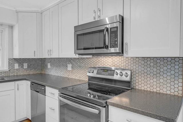 1515 Chance Ct, Adel, IA 50003 - kitchen with appliances with stainless steel finishes, dark countertops, and white cabinets