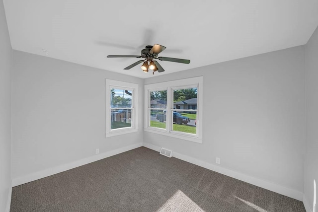 1515 Chance Ct, Adel, IA 50003 - spare room featuring dark colored carpet and a ceiling fan