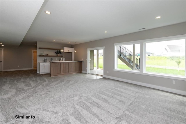 790 Hamilton Rd, Waukee, IA 50263 - unfurnished living room with light colored carpet and recessed lighting
