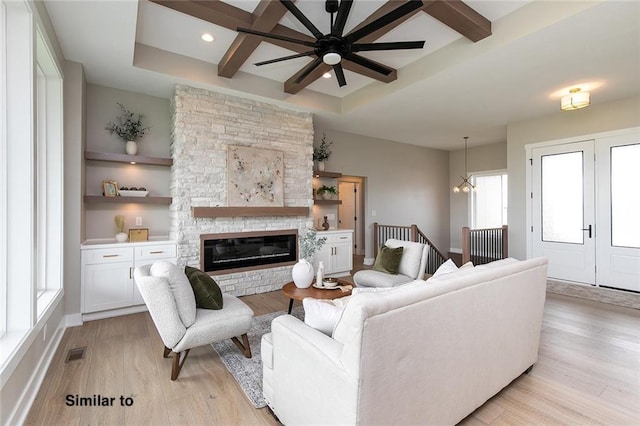790 Hamilton Rd, Waukee, IA 50263 - living room featuring light wood-style flooring, coffered ceiling, beamed ceiling, a stone fireplace, and a ceiling fan