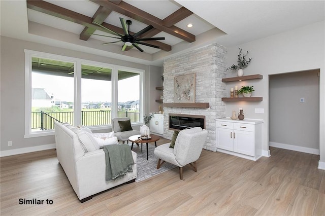 790 Hamilton Rd, Waukee, IA 50263 - living area featuring coffered ceiling, healthy amount of natural light, a fireplace, a ceiling fan, and light wood finished floors