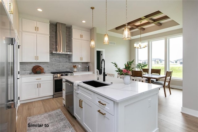 790 Hamilton Rd, Waukee, IA 50263 - kitchen featuring wall chimney exhaust hood, stainless steel appliances, decorative backsplash, recessed lighting, and light wood-type flooring