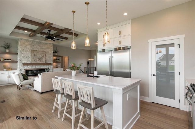790 Hamilton Rd, Waukee, IA 50263 - kitchen featuring stainless steel appliances, coffered ceiling, a ceiling fan, recessed lighting, and wood finished floors