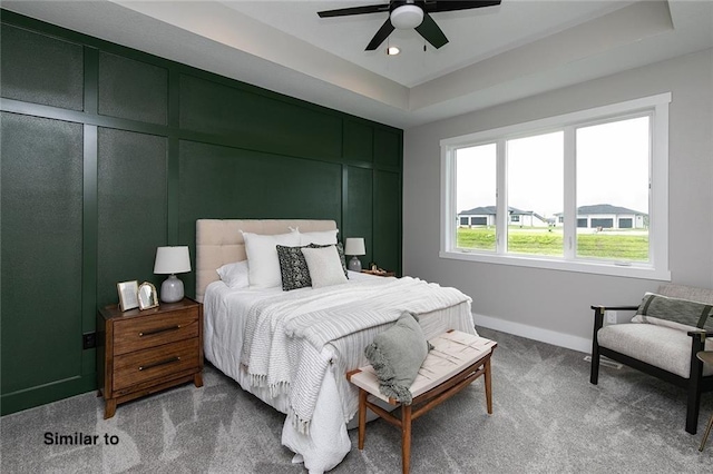 790 Hamilton Rd, Waukee, IA 50263 - carpeted bedroom with a decorative wall, ceiling fan, and a raised ceiling