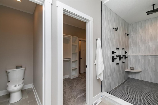 790 Hamilton Rd, Waukee, IA 50263 - full bathroom with tiled shower, a walk in closet, and tile patterned floors