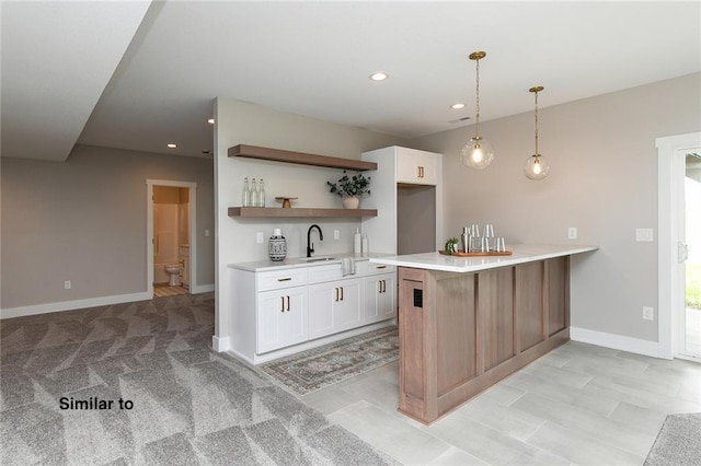 790 Hamilton Rd, Waukee, IA 50263 - kitchen featuring open shelves, a peninsula, white cabinets, light countertops, and recessed lighting