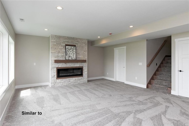 790 Hamilton Rd, Waukee, IA 50263 - unfurnished living room with carpet floors, a stone fireplace, stairs, and recessed lighting
