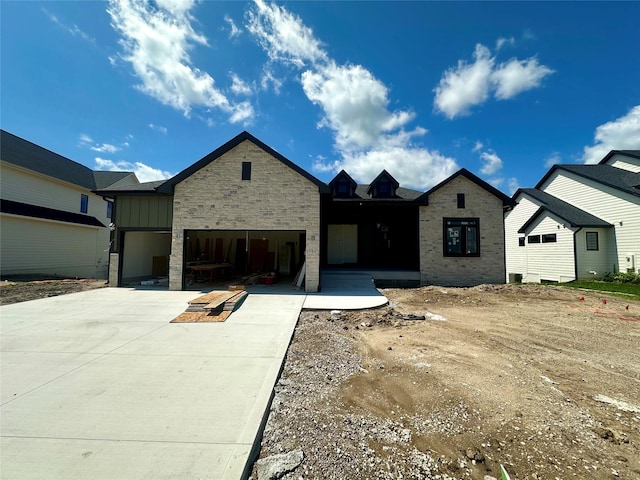 790 Hamilton Rd, Waukee, IA 50263 - view of front of home featuring driveway, a garage, stone siding, and board and batten siding