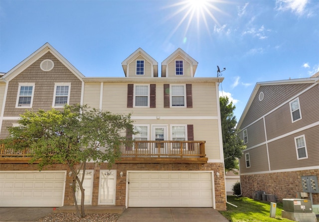 1115 Fieldstone Ln, Pleasant Hill, IA 50327 - view of front of house featuring driveway, a garage, and stone siding