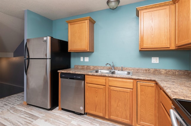 1115 Fieldstone Ln, Pleasant Hill, IA 50327 - kitchen with appliances with stainless steel finishes, light countertops, light brown cabinetry, light wood-style flooring, and a textured ceiling