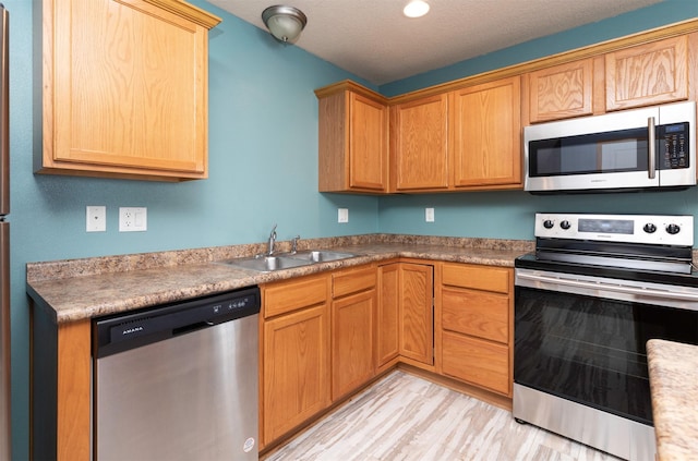 1115 Fieldstone Ln, Pleasant Hill, IA 50327 - kitchen with stainless steel appliances and light wood-style flooring