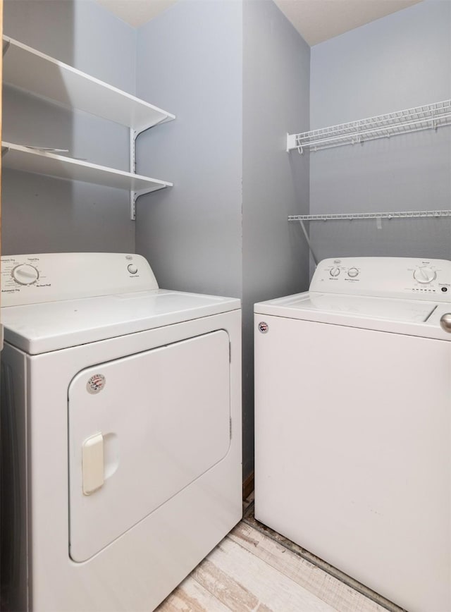 1115 Fieldstone Ln, Pleasant Hill, IA 50327 - laundry room with separate washer and dryer and light wood-type flooring