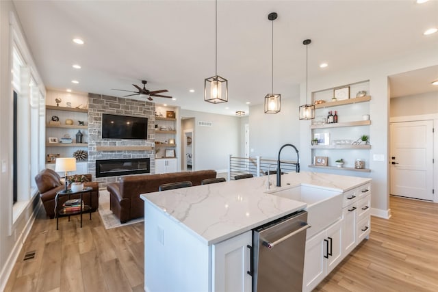 17965 Hammontree Cir, Clive, IA 50325 - kitchen with dishwasher, open shelves, a ceiling fan, light wood-type flooring, and white cabinetry