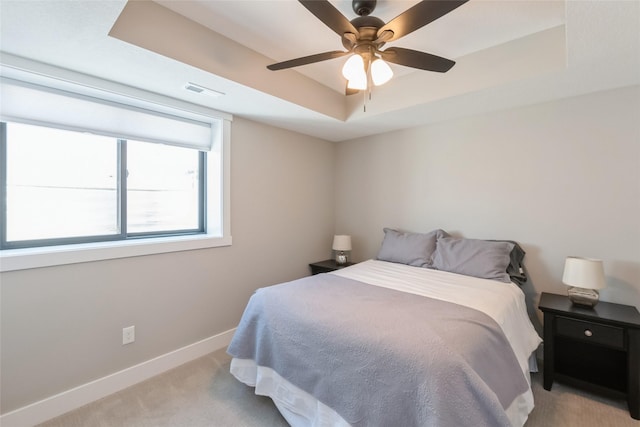 17965 Hammontree Cir, Clive, IA 50325 - bedroom with a tray ceiling, light carpet, and a ceiling fan