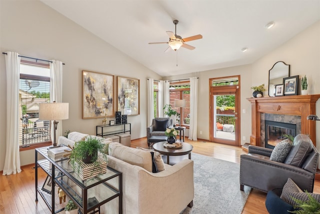 3607 152nd St, Urbandale, IA 50323 - living area with lofted ceiling, ceiling fan, light wood-type flooring, and a fireplace