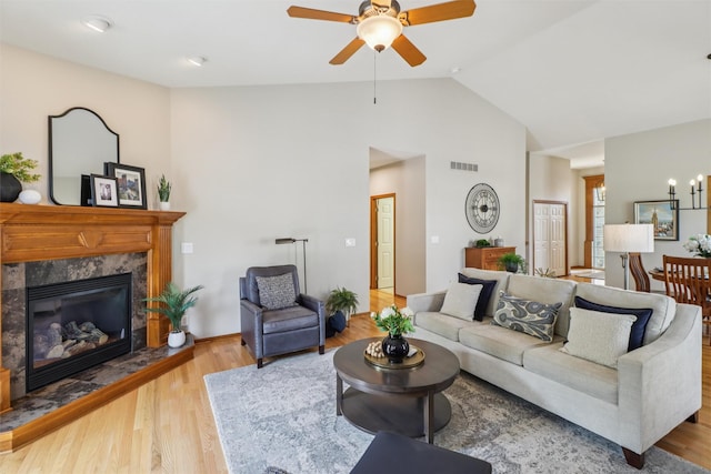3607 152nd St, Urbandale, IA 50323 - living room with a ceiling fan, wood finished floors, high vaulted ceiling, and a high end fireplace