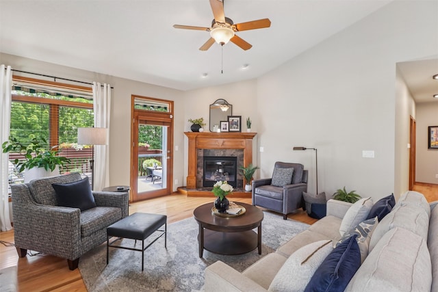 3607 152nd St, Urbandale, IA 50323 - living area with light wood-style floors, ceiling fan, a premium fireplace, and vaulted ceiling