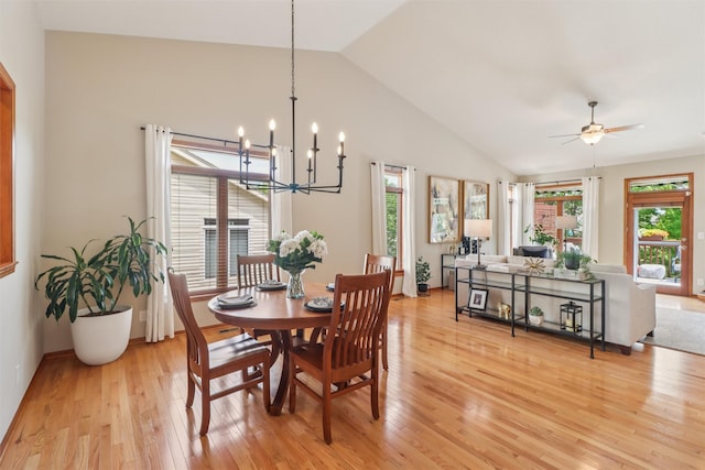 3607 152nd St, Urbandale, IA 50323 - dining space featuring light wood finished floors, vaulted ceiling, a chandelier, and ceiling fan