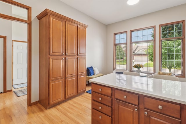 3607 152nd St, Urbandale, IA 50323 - kitchen featuring light countertops, brown cabinetry, and light wood finished floors