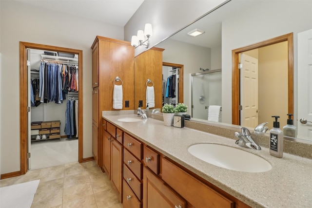 3607 152nd St, Urbandale, IA 50323 - full bath with double vanity, a shower stall, a spacious closet, and tile patterned floors
