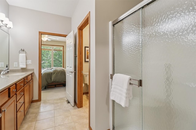3607 152nd St, Urbandale, IA 50323 - bathroom with ceiling fan, vanity, a stall shower, tile patterned floors, and ensuite bathroom