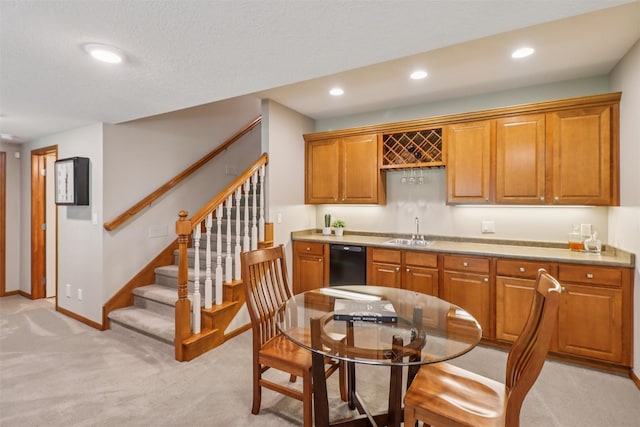 3607 152nd St, Urbandale, IA 50323 - kitchen featuring dishwasher, light colored carpet, brown cabinets, recessed lighting, and light countertops