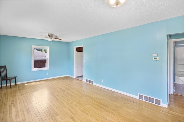 217 E Park Ave, Des Moines, IA 50315 - empty room with ceiling fan, wood finished floors, and a textured ceiling