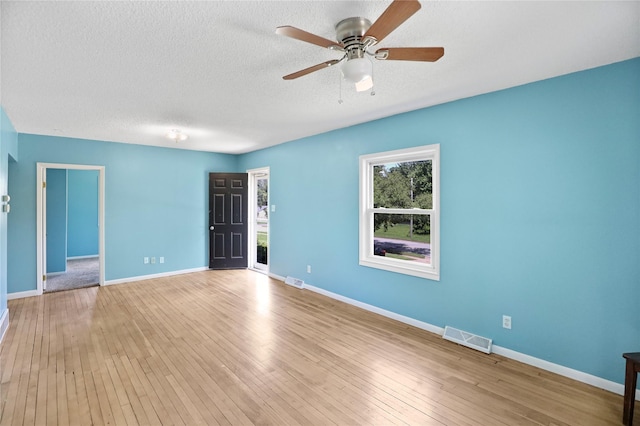 217 E Park Ave, Des Moines, IA 50315 - empty room with ceiling fan, hardwood / wood-style floors, and a textured ceiling