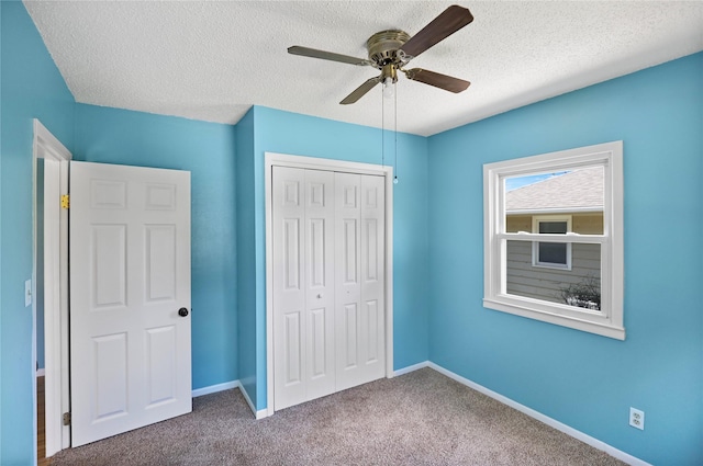217 E Park Ave, Des Moines, IA 50315 - unfurnished bedroom with a textured ceiling, a closet, carpet flooring, and a ceiling fan