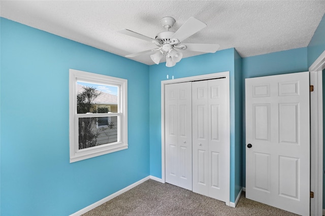 217 E Park Ave, Des Moines, IA 50315 - unfurnished bedroom with carpet, a closet, a textured ceiling, and a ceiling fan
